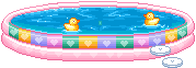 a gif of a pink, inflatable swimming pool with rubber ducks swimming in it.